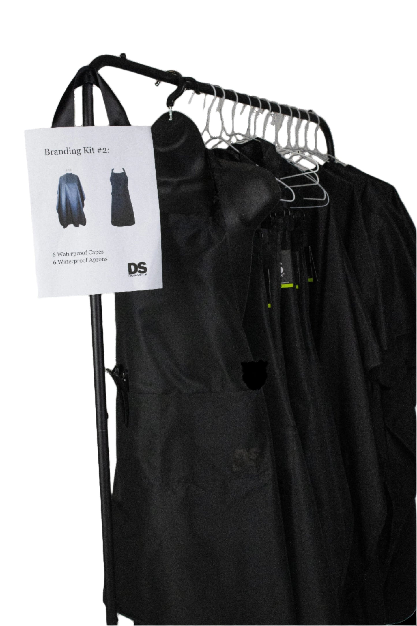 A black apron hanging on a hanger with a black shirt