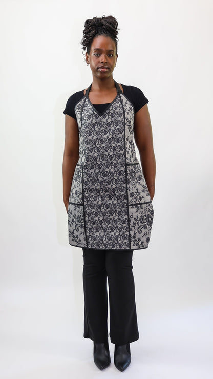 stylist wearing black and ivory lace apron
