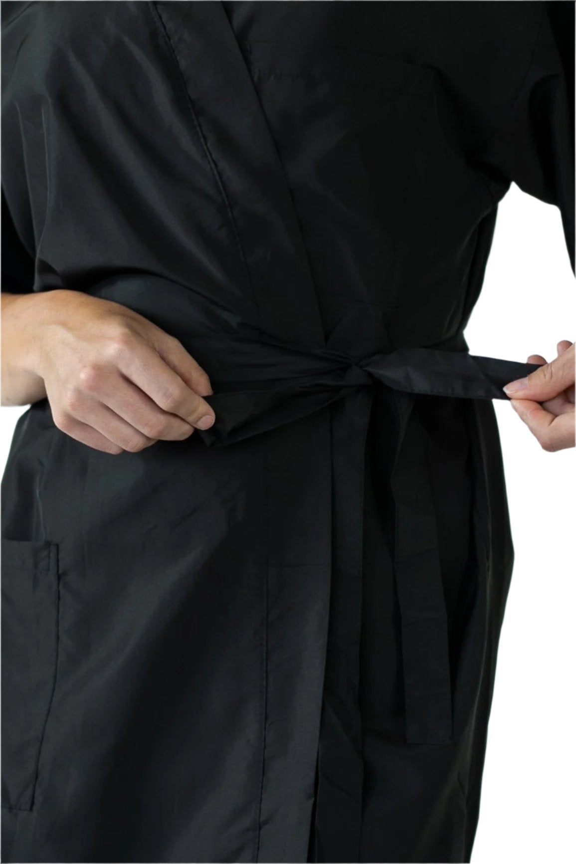 A woman in a black robe is seen adjusting her belt